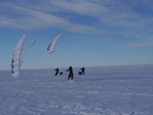 Three men with ski sails on the Ross ice shelf.