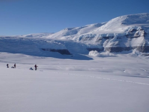 Skiers in a mountainous landscape in Antarctica.