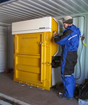 A man and a waste compactor at the Troll research station in Antarctica.